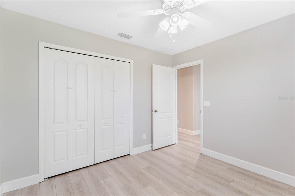 337 Partridge Pea Lane Ocoee, FL 34761 - Photo 21 of 38 an empty room with a hardwood and ceiling fan