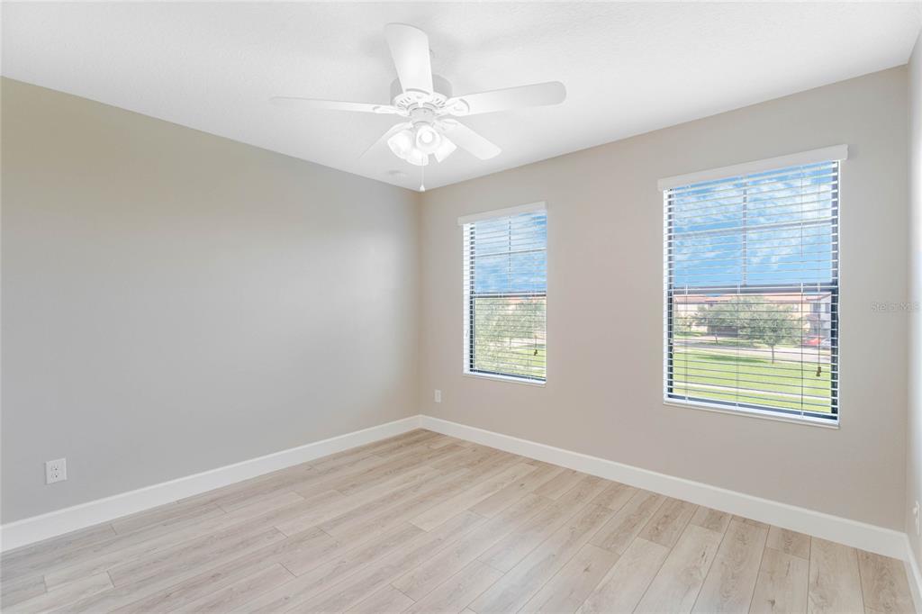 337 Partridge Pea Lane Ocoee, FL 34761 - Photo 22 of 38 a view of an empty room with wooden floor and a window