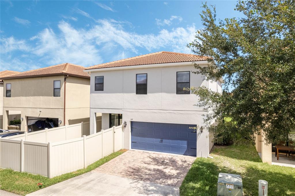 337 Partridge Pea Lane Ocoee, FL 34761 - Photo 33 of 38 a front view of a house with a garden