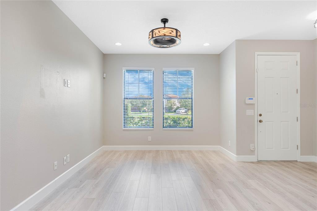 337 Partridge Pea Lane Ocoee, FL 34761 - Photo 4 of 38 an empty room with wooden floor and windows