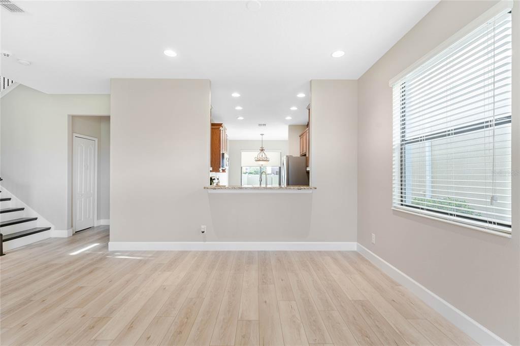 337 Partridge Pea Lane Ocoee, FL 34761 - Photo 6 of 38 an empty room with wooden floor and windows