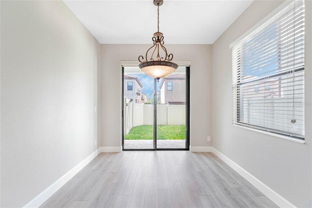 337 Partridge Pea Lane Ocoee, FL 34761 - Photo 9 of 38 a view of a room with wooden floor chandelier and windows