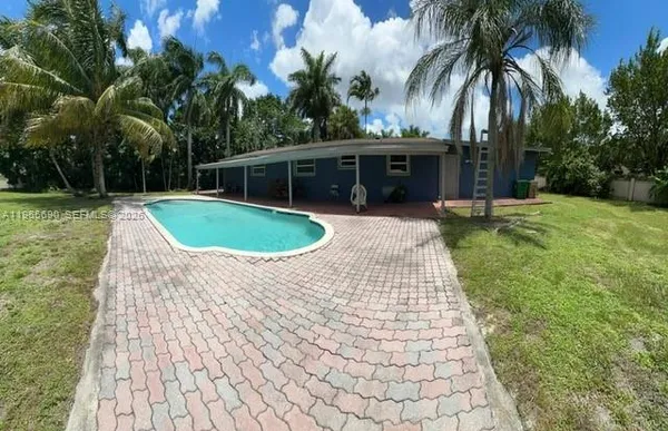 a view of a backyard with palm trees