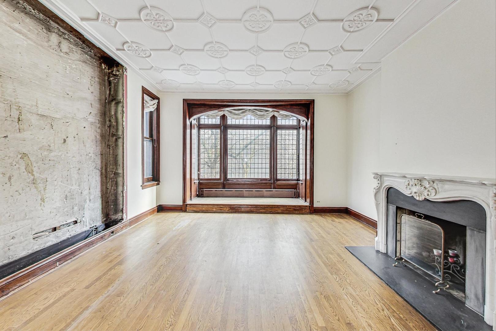 1310 North Astor Street Chicago, IL 60610 - Photo 14 of 33 a view of an empty room with a fireplace and a window