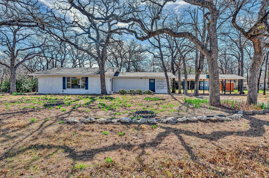 a house that has a tree in front of it