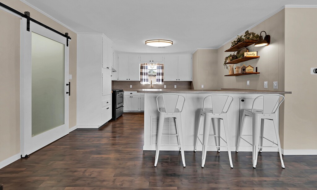 122 Teeling Trail Whitney, TX 76692 - Photo 16 of 31 a kitchen with white cabinets and chairs