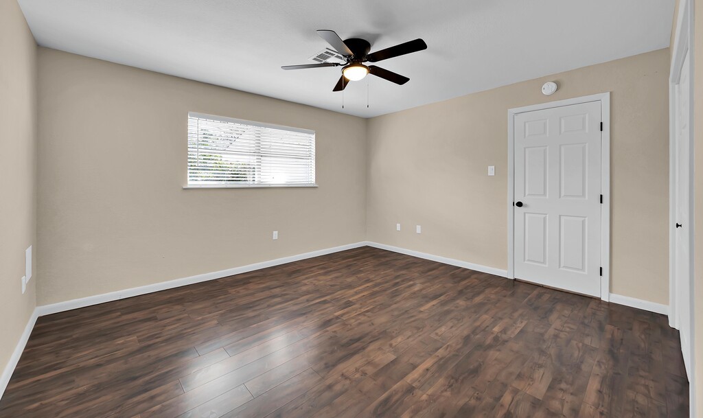 122 Teeling Trail Whitney, TX 76692 - Photo 25 of 31 an empty room with wooden floor and windows