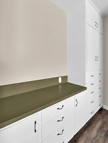 a kitchen with white cabinets and a sink