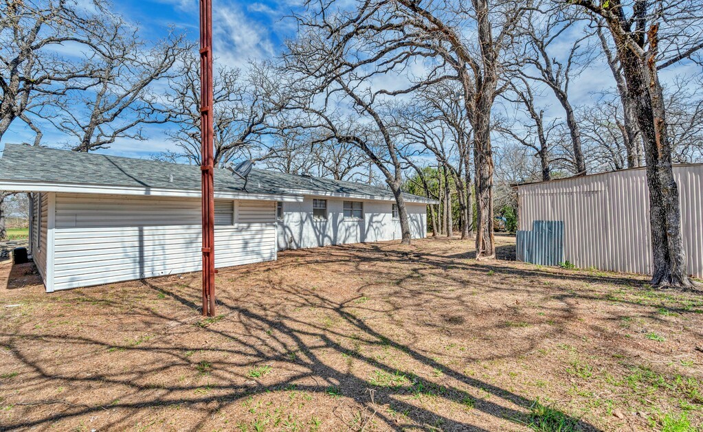 122 Teeling Trail Whitney, TX 76692 - Photo 6 of 31 a view of a backyard with a large tree