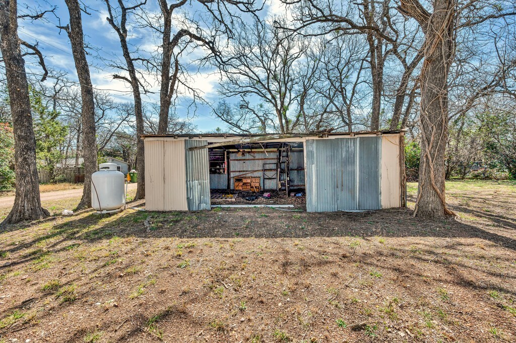 122 Teeling Trail Whitney, TX 76692 - Photo 8 of 31 a view of a house with a yard and garage