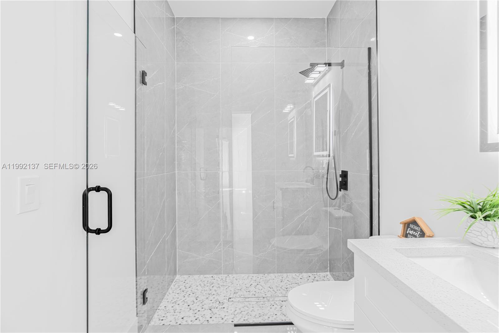 747 Roma Avenue South Lehigh Acres, FL 33974 - Photo 13 of 31 a bathroom with a sink toilet and shower