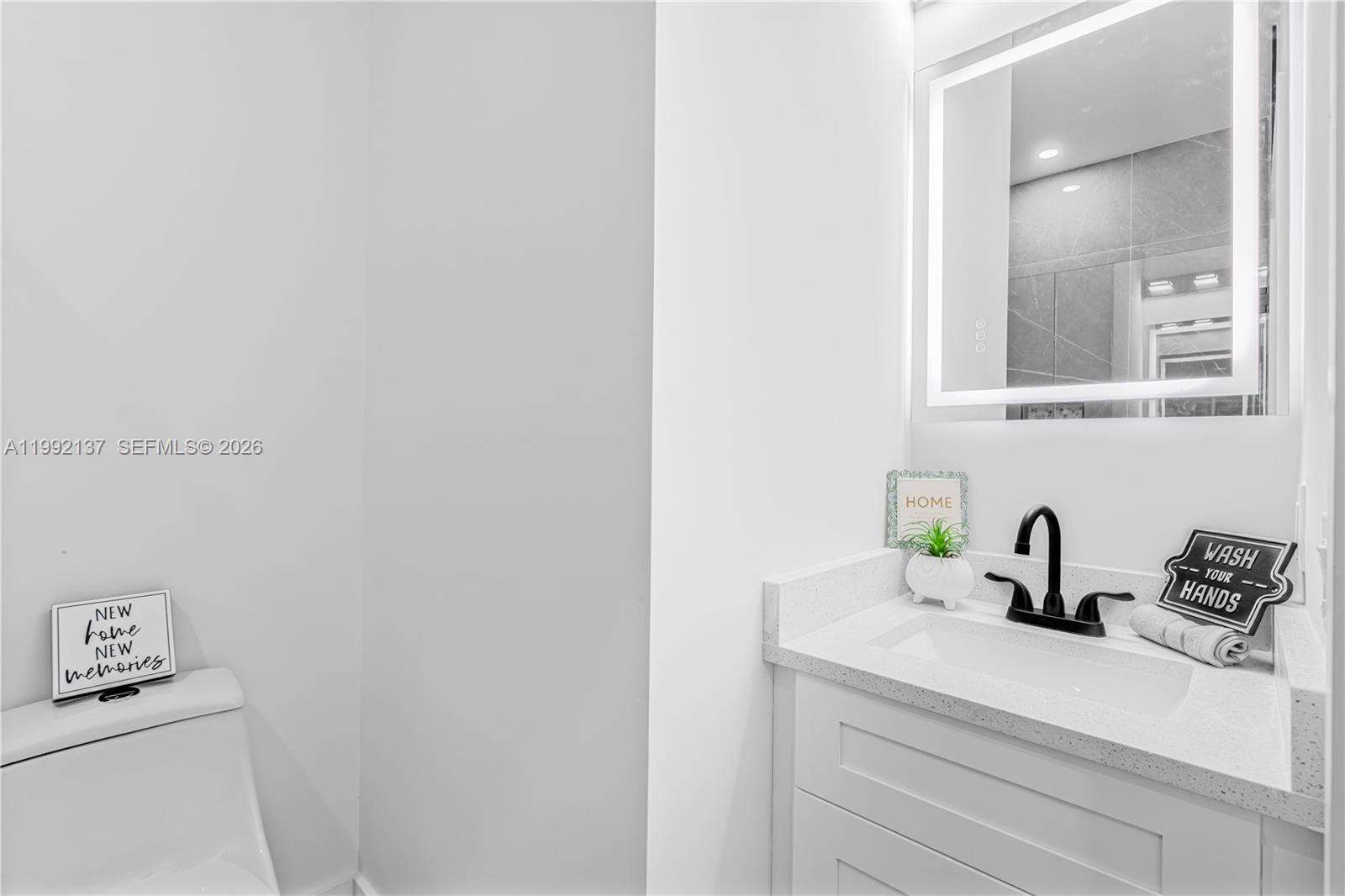 747 Roma Avenue South Lehigh Acres, FL 33974 - Photo 17 of 31 a bathroom with a sink and a mirror