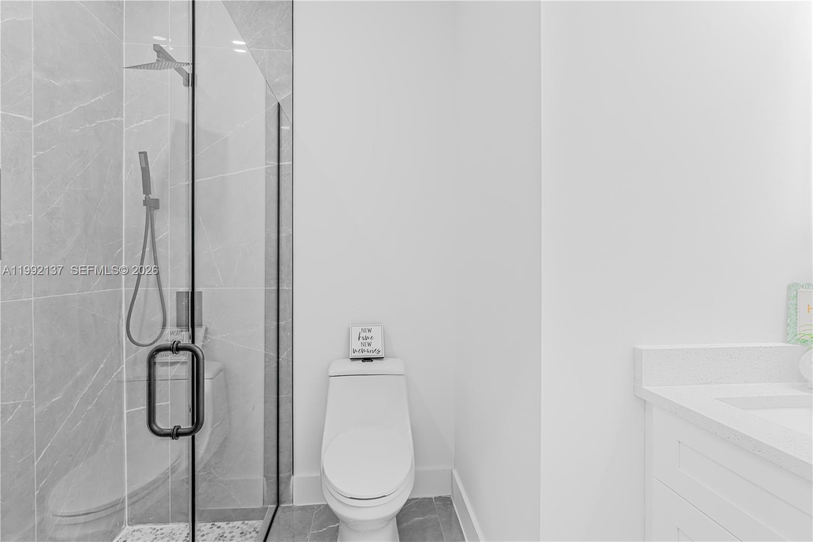 747 Roma Avenue South Lehigh Acres, FL 33974 - Photo 18 of 31 a bathroom with a toilet and a shower