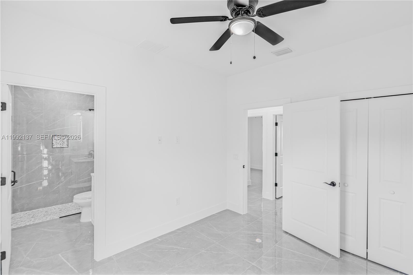 747 Roma Avenue South Lehigh Acres, FL 33974 - Photo 22 of 31 a view of a hallway with a shower and a sink