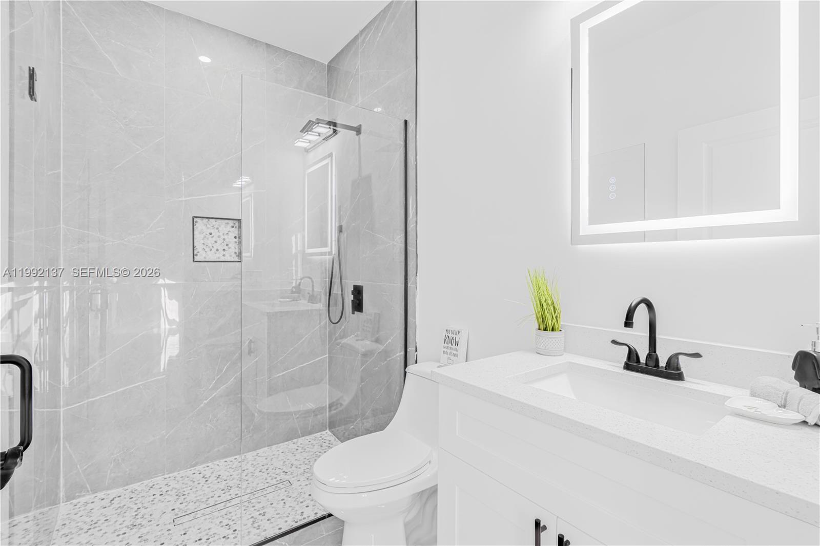 747 Roma Avenue South Lehigh Acres, FL 33974 - Photo 23 of 31 a bathroom with a sink toilet and shower