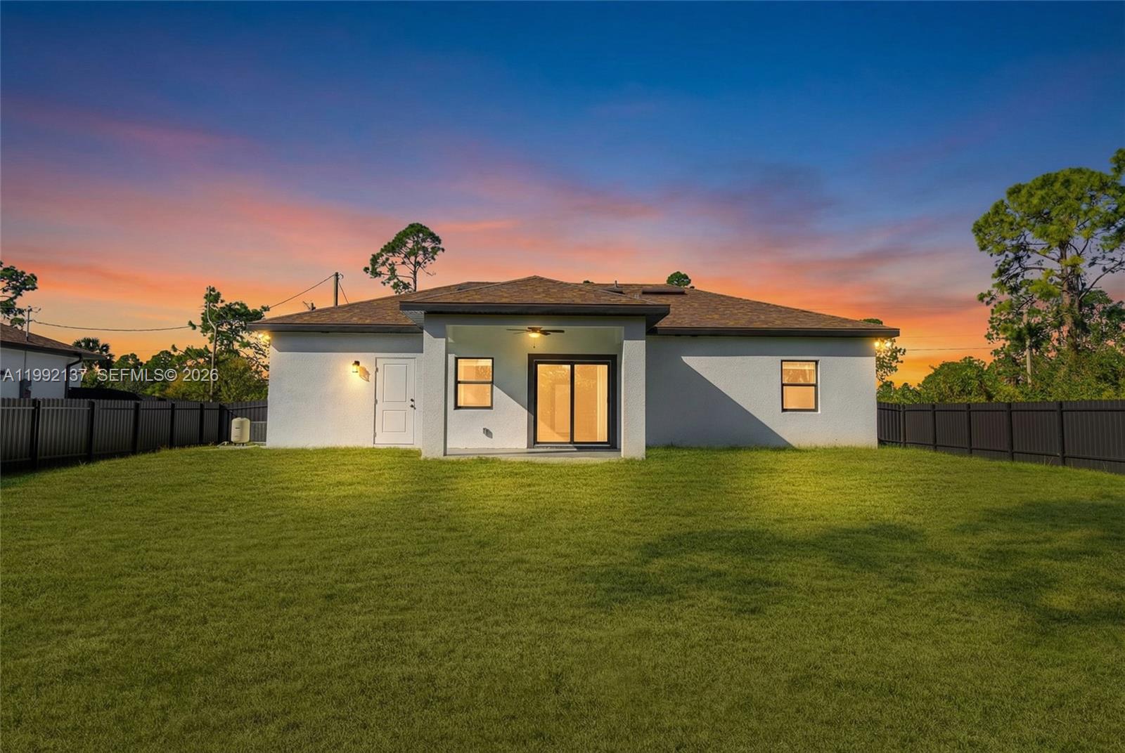 747 Roma Avenue South Lehigh Acres, FL 33974 - Photo 29 of 31 a big yard with wooden fence