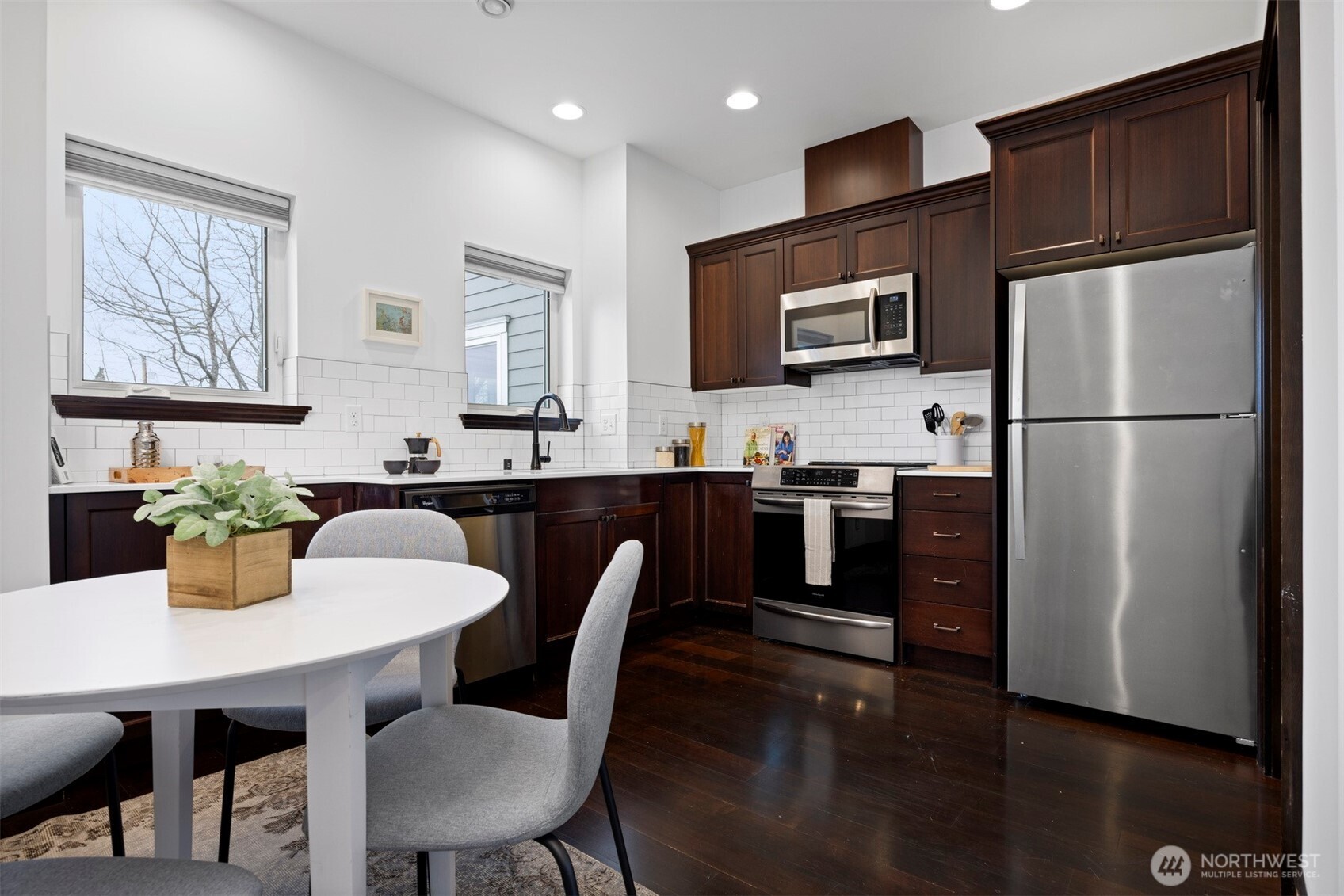2011 Cornwall Avenue Bellingham, WA 98225 - Photo 13 of 30 a kitchen with stainless steel appliances granite countertop a dining table chairs refrigerator and sink
