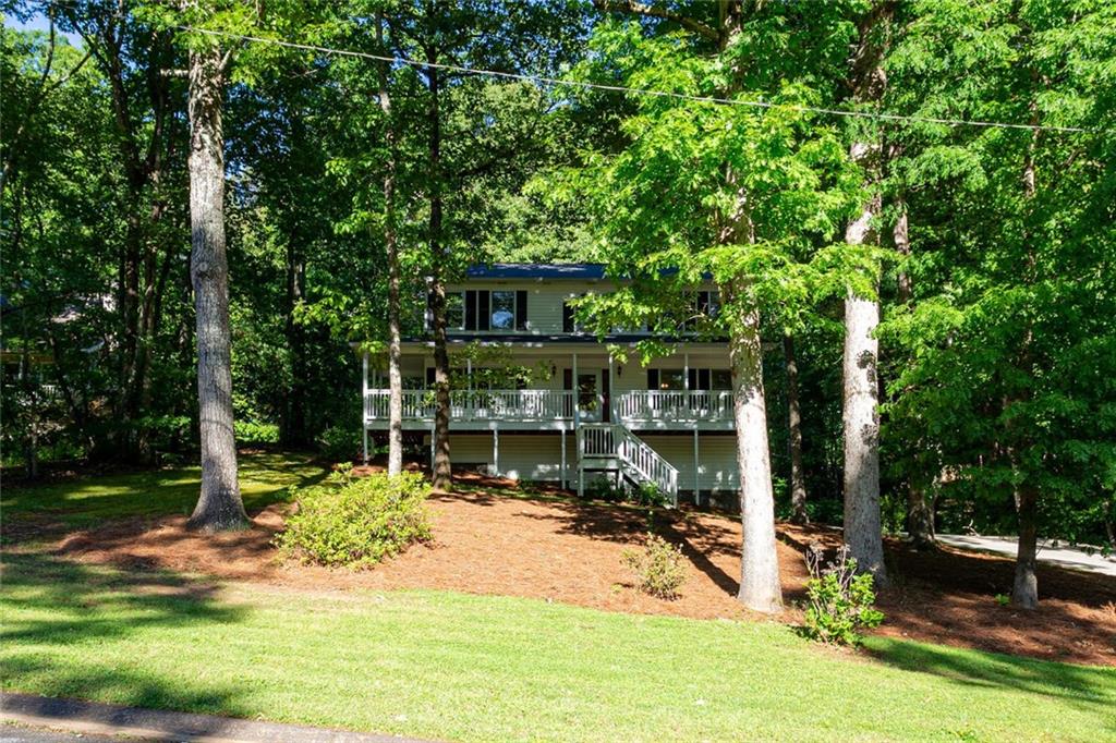 a view of a house with backyard and sitting area