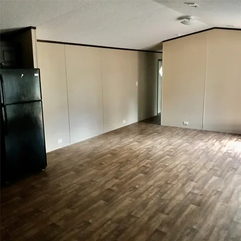 a view of a big room with closet and wooden floor
