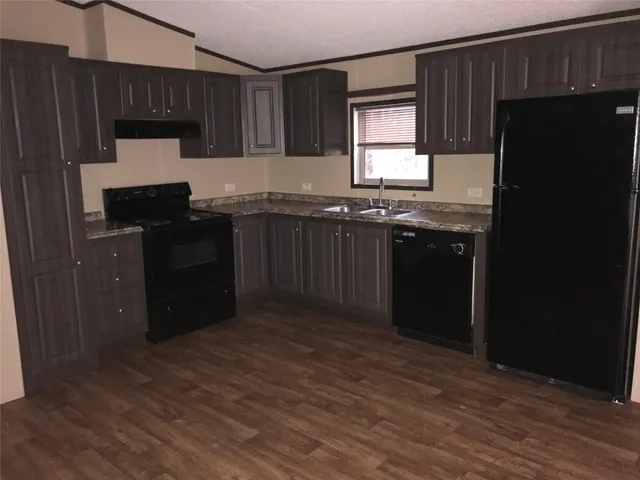 a kitchen with granite countertop wooden cabinets and a granite counter top