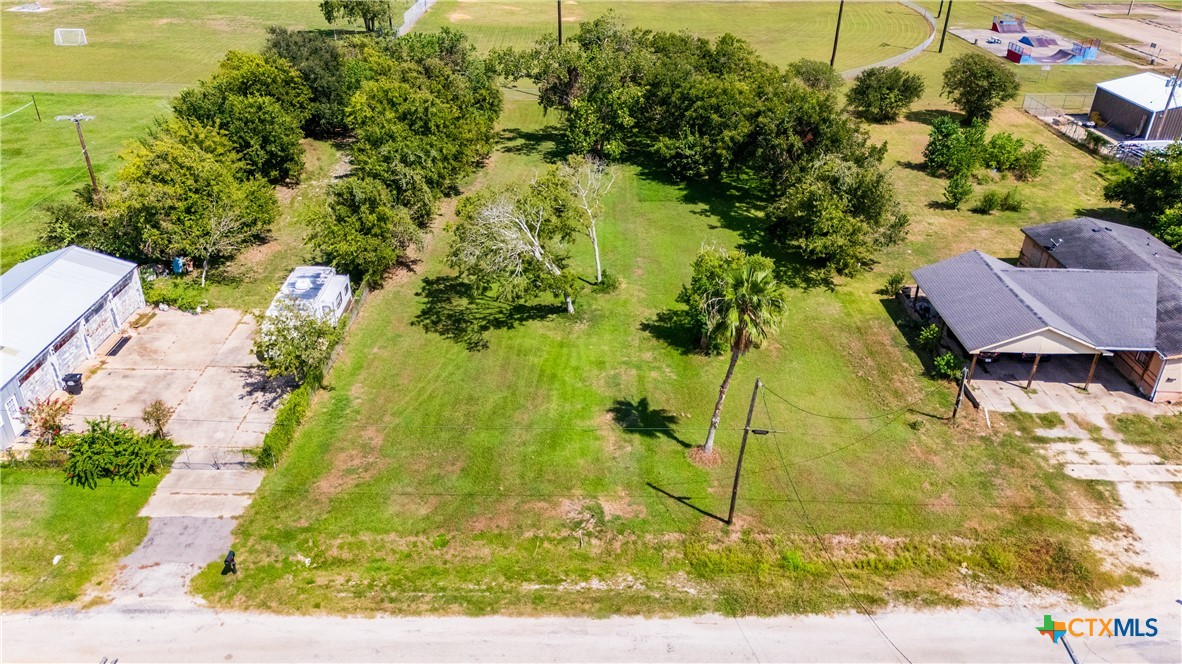 404 8th Street Palacios, TX 77465 - Photo 6 of 6 a backyard of a house with yard and outdoor seating