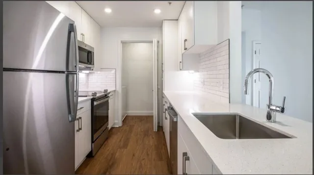 a kitchen with a refrigerator sink and stainless steel appliances