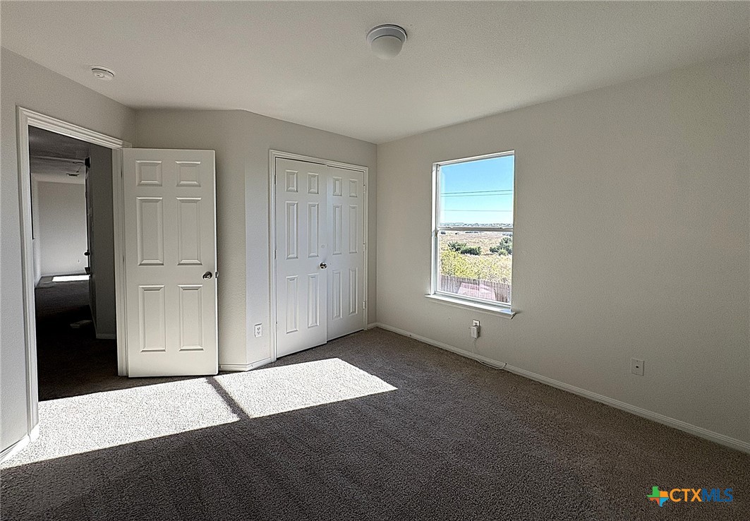 6502 Griffith Loop Killeen, TX 76549 - Photo 12 of 22 a view of an empty room with window and closet area