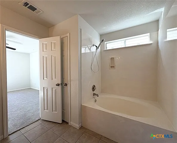 a bathroom with a bathtub and a shower