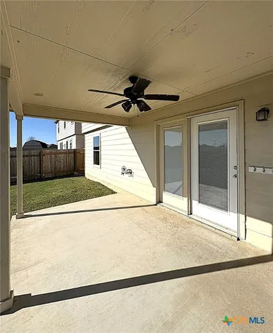 a view of a living room with a ceiling fan