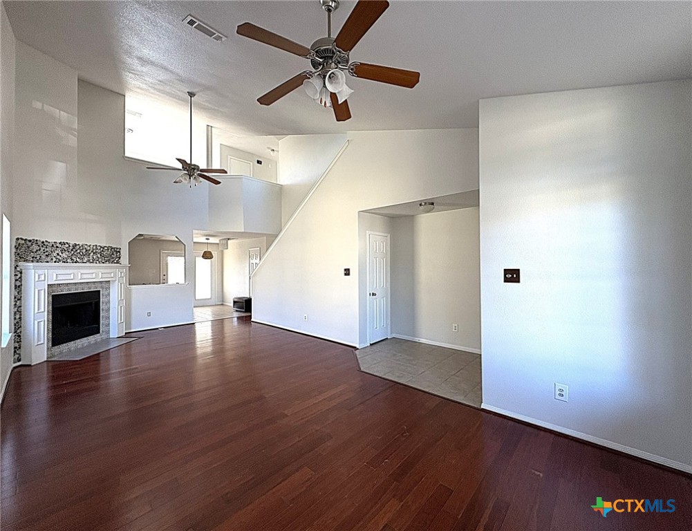 6502 Griffith Loop Killeen, TX 76549 - Photo 3 of 22 an empty room with wooden floor fireplace and windows