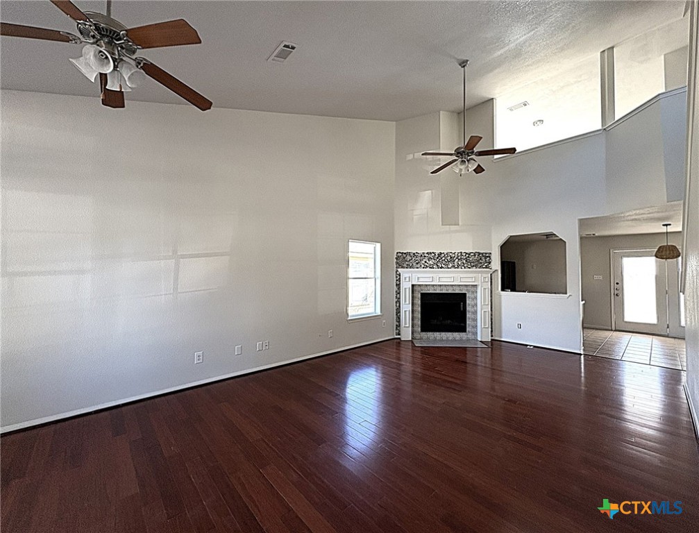 6502 Griffith Loop Killeen, TX 76549 - Photo 6 of 22 wooden floor fireplace and windows in an empty room