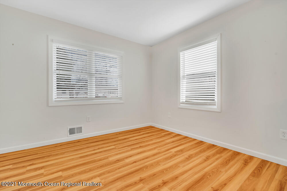 42 Harborage Avenue Bayville, NJ 08721 - Photo 14 of 35 a view of an empty room with wooden floor and a window