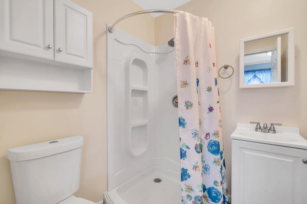 42 Harborage Avenue Bayville, NJ 08721 - Photo 21 of 35 a bathroom with a shower curtain and a sink