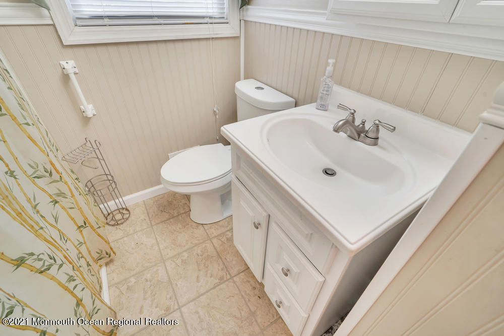 42 Harborage Avenue Bayville, NJ 08721 - Photo 25 of 35 a bathroom with a sink mirror and toilet