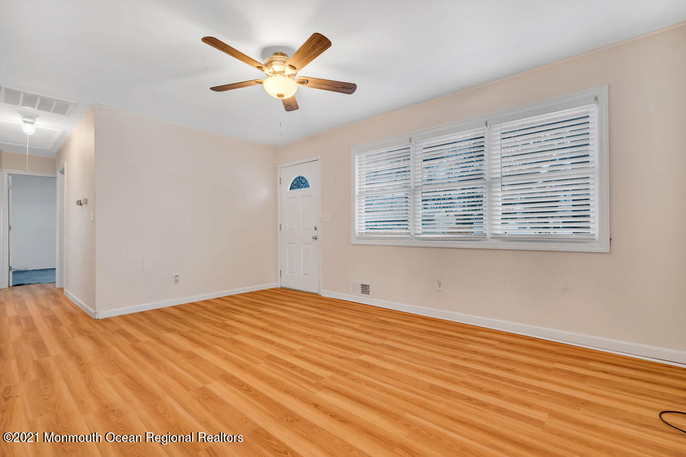 42 Harborage Avenue Bayville, NJ 08721 - Photo 6 of 35 a view of an empty room with wooden floor and a window