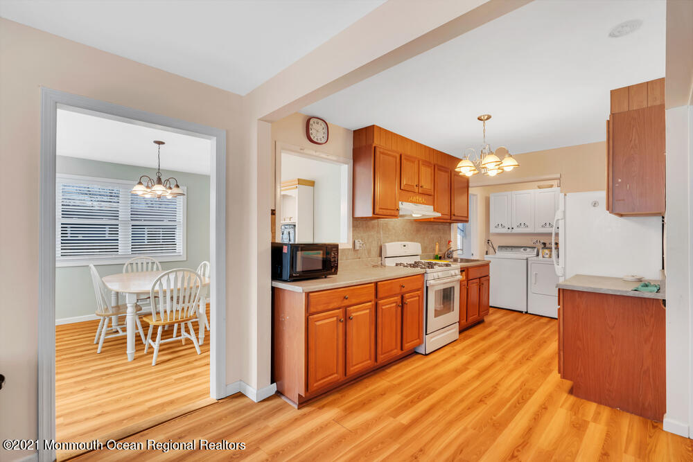 42 Harborage Avenue Bayville, NJ 08721 - Photo 8 of 35 a large kitchen with stainless steel appliances granite countertop a stove and a sink