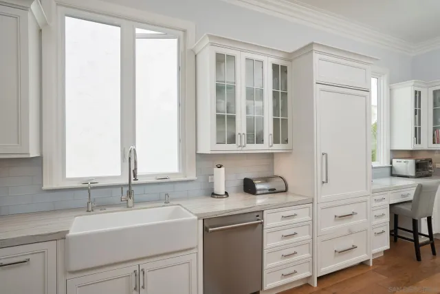 a bedroom with a large bed and a large window