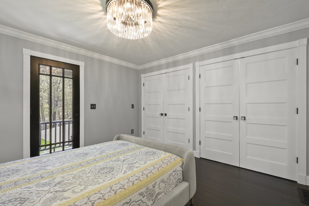 52 Fales Road Plainville, MA 02762 - Photo 26 of 41 a bedroom with a bed and a chandelier