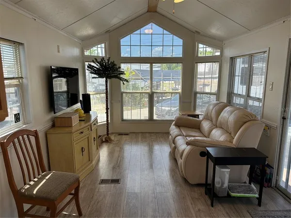 a living room with furniture fireplace and a large window