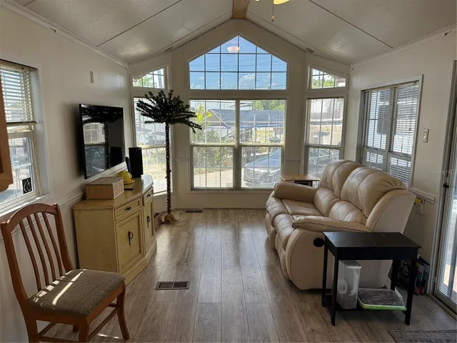 a living room with furniture fireplace and a large window