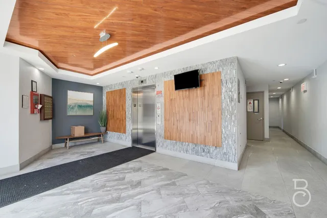 a view of a hallway with wooden fence