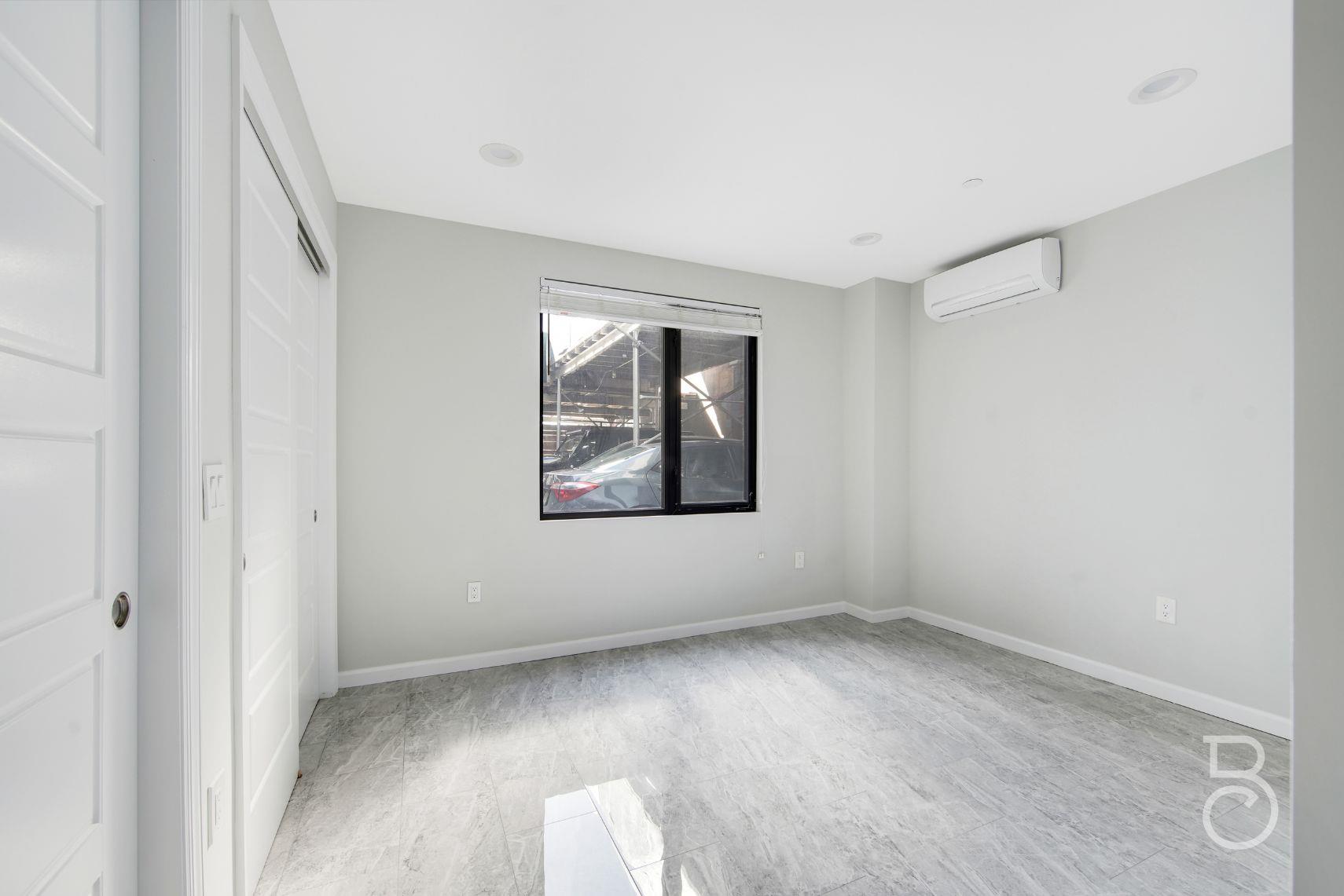 31-10 28th Road, Unit 1A Queens, NY 11102 - Photo 5 of 12 an empty room with windows