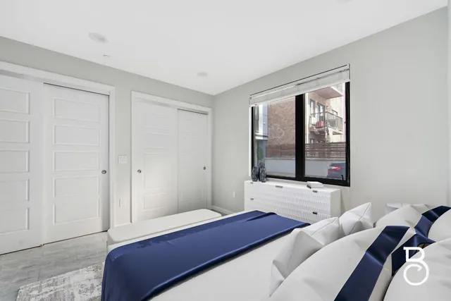 a bedroom with a bed and window