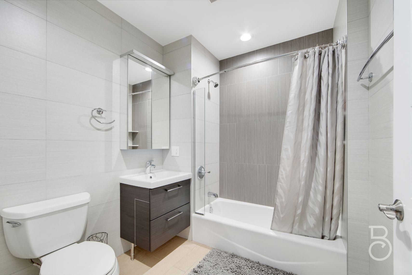 31-10 28th Road, Unit 1A Queens, NY 11102 - Photo 10 of 12 a bathroom with a sink toilet and shower