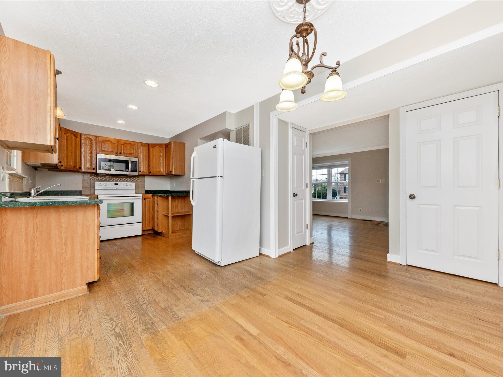 1116 Keswick Place Frederick, MD 21703 - Photo 11 of 53 a open kitchen with a refrigerator a stove top oven a sink and dishwasher
