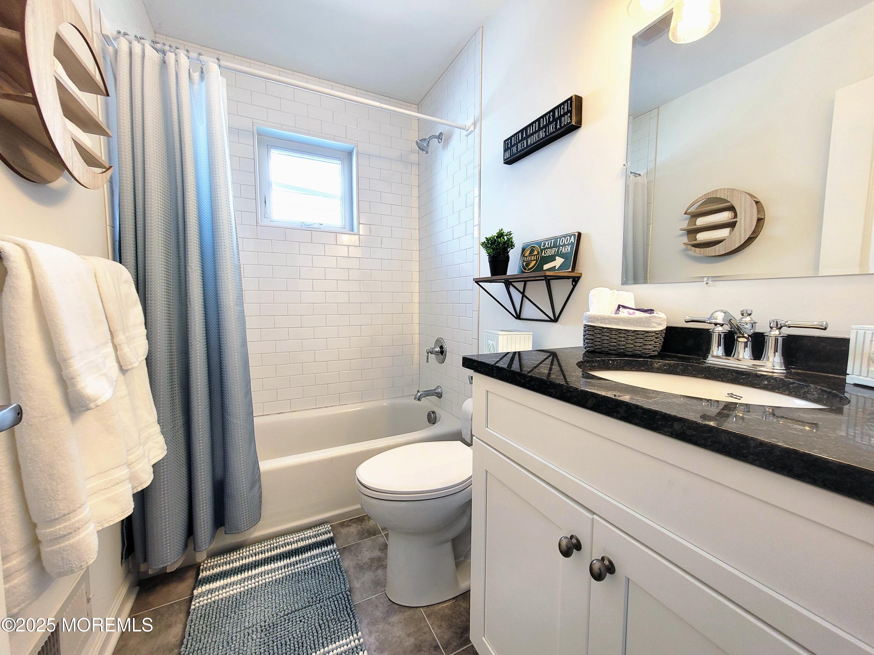 1134 Springwood Avenue, Unit B Asbury Park, NJ 07712 - Photo 12 of 19 a bathroom with a granite countertop sink mirror vanity and toilet
