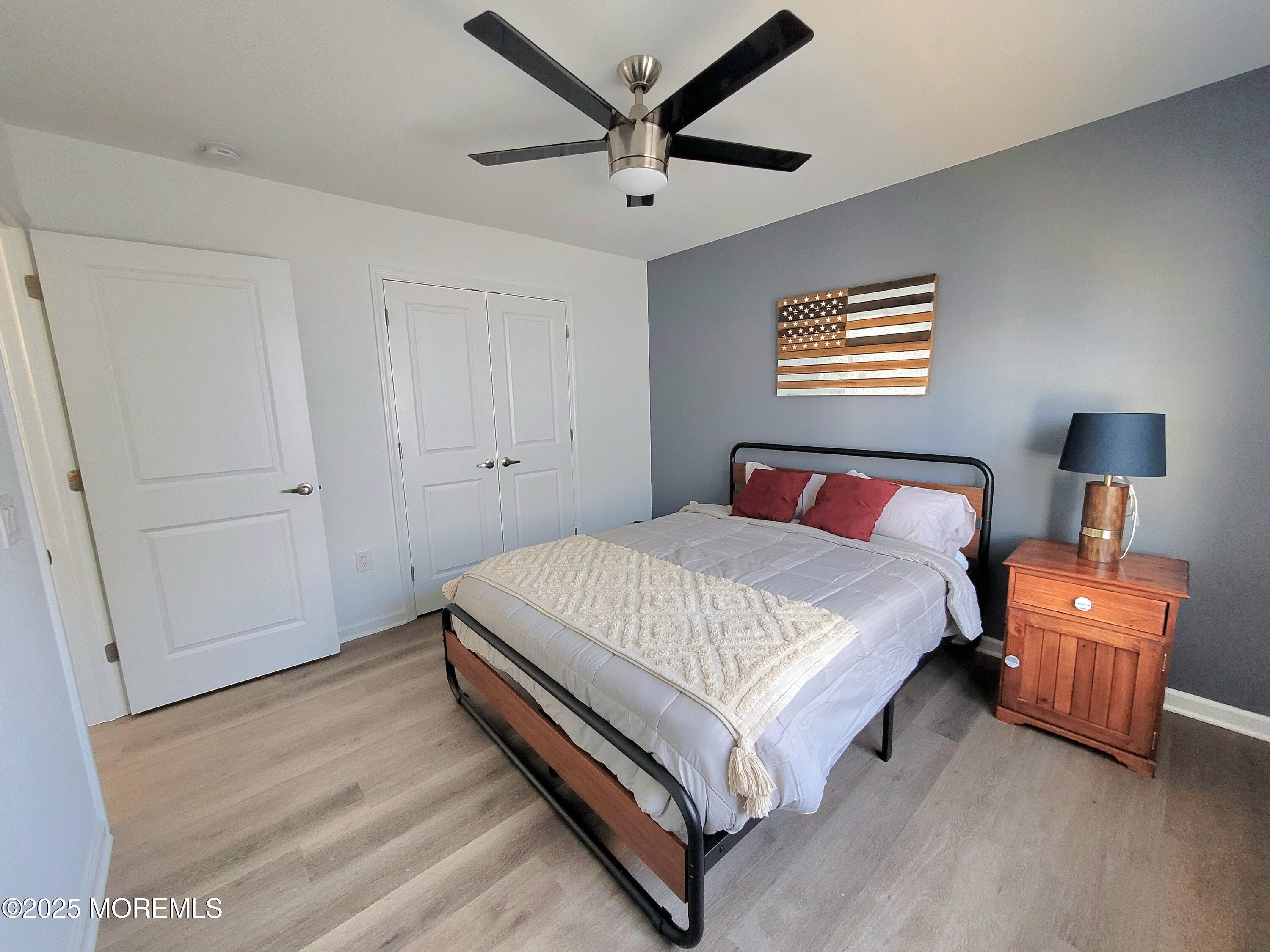 1134 Springwood Avenue, Unit B Asbury Park, NJ 07712 - Photo 16 of 19 a bed room with a bed and a chandelier