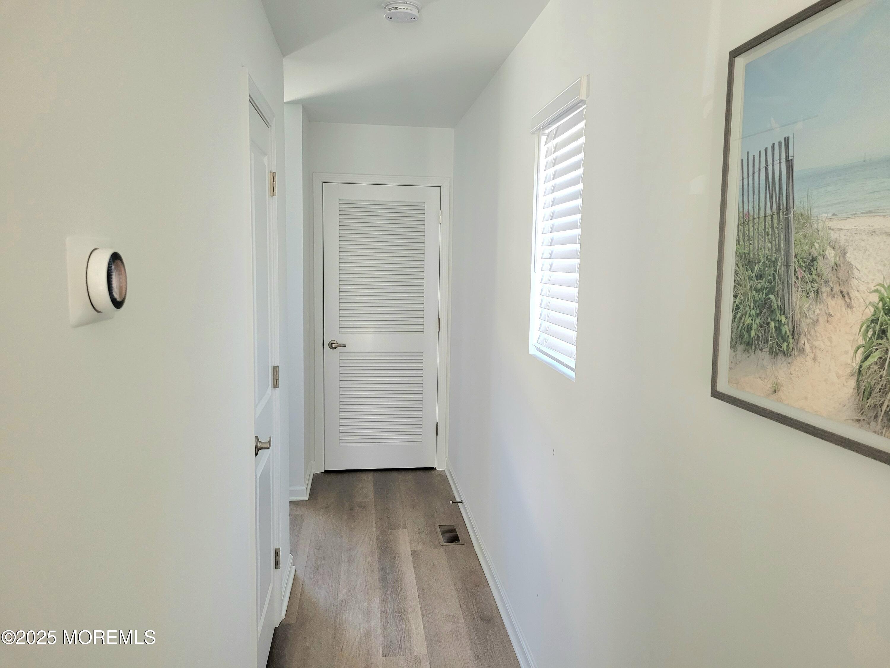 1134 Springwood Avenue, Unit B Asbury Park, NJ 07712 - Photo 17 of 19 a view of a hallway with wooden floor and closet