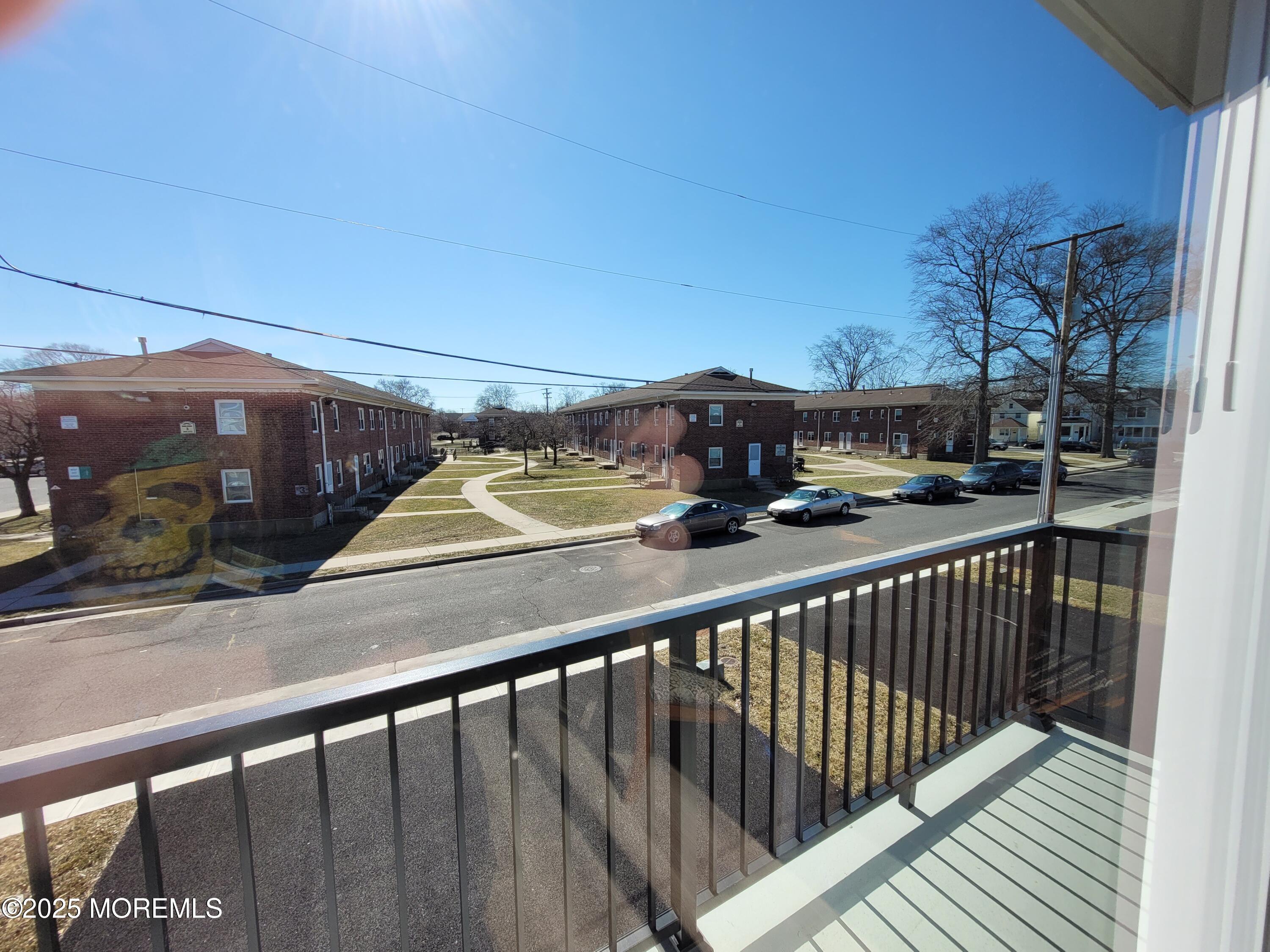 1134 Springwood Avenue, Unit B Asbury Park, NJ 07712 - Photo 19 of 19 a view of a balcony with a car parked on the street