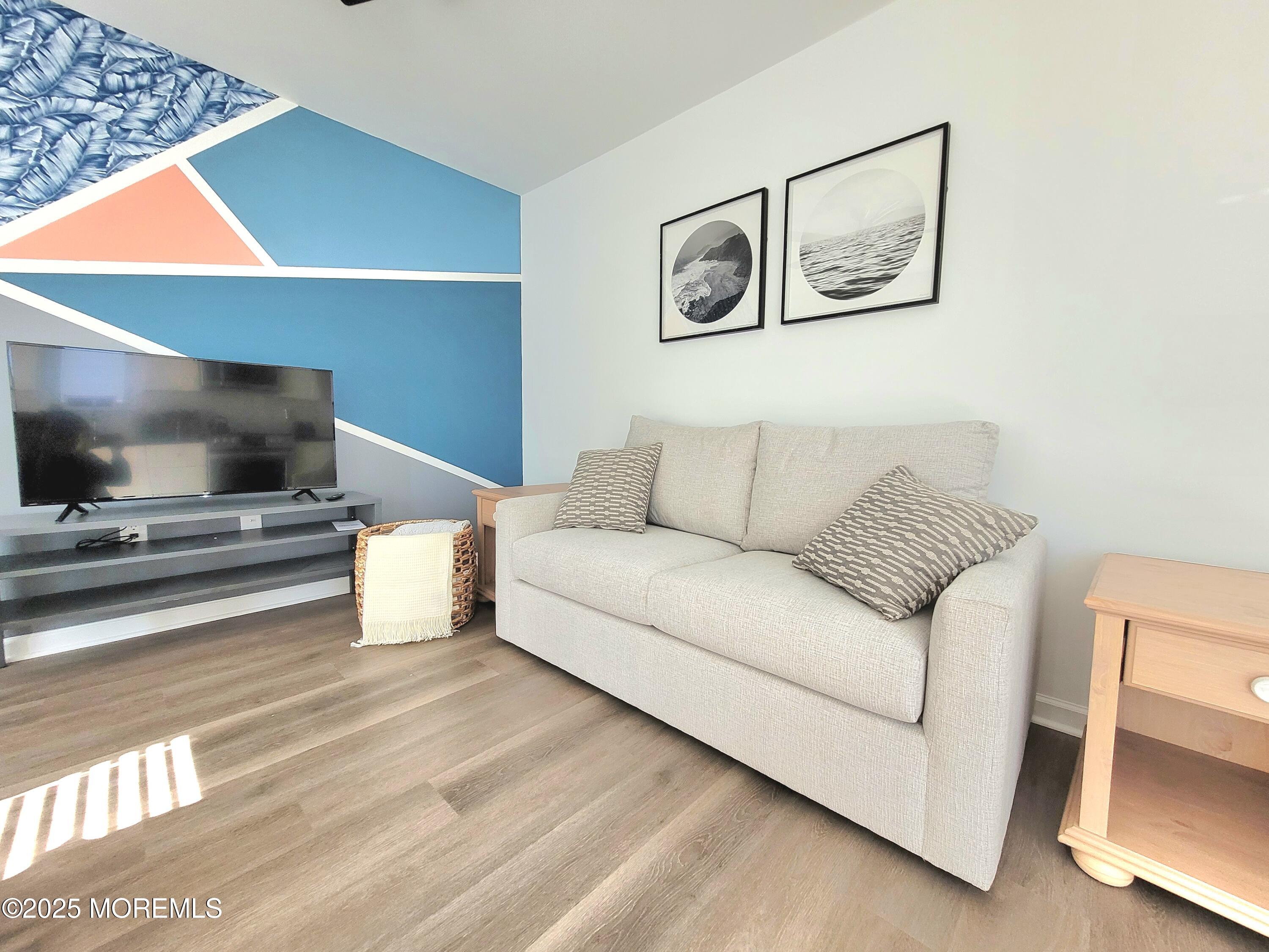 1134 Springwood Avenue, Unit B Asbury Park, NJ 07712 - Photo 7 of 19 a living room with furniture and a flat screen tv